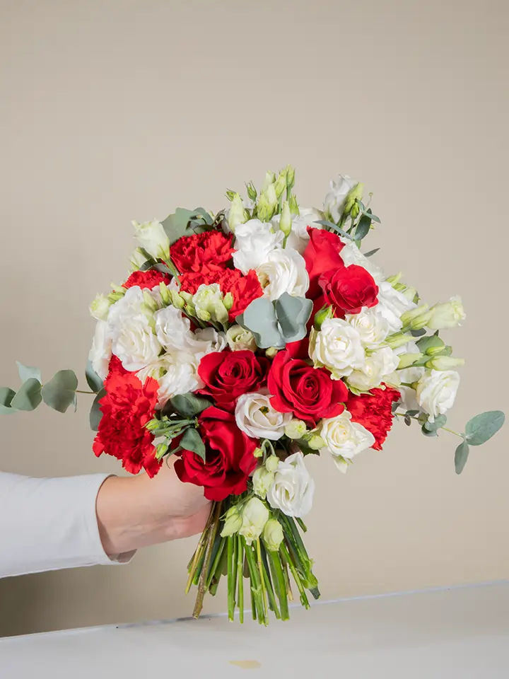 Bouquet bianco e rosso in mano